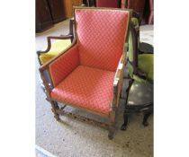 EDWARDIAN MAHOGANY FRAMED ARMCHAIR WITH RED FLORAL UPHOLSTERY WITH CARVED FRONT PANEL