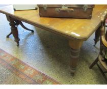 EDWARDIAN MAHOGANY EXTENDING DINING TABLE WITH CANTED CORNERS AND REEDED LEGS, RAISED ON PORCELAIN