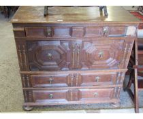 Early 18th century oak chest of four graduated drawers, all with geometric dummy fronts, raised on