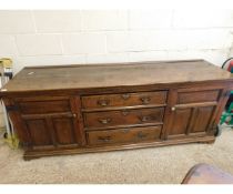 EARLY 18TH CENTURY OAK DRESSER BASE WITH THREE DRAWERS FLANKED EITHER SIDE BY PANELLED CUPBOARD