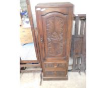GOTHIC OAK FRAMED TALLBOY CABINET WITH SINGLE CARVED DOOR OVER TWO FULL WIDTH DRAWERS WITH BRASS