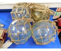 THREE GLASS BALLS IN NETS