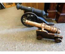 SMALL REPRODUCTION CAST IRON CANNON ON STAND ORNAMENT, TOGETHER WITH A FURTHER SMALLER EXAMPLE ON