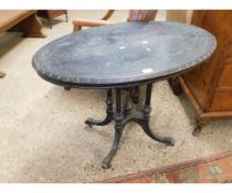 AESTHETIC PERIOD OVAL CENTRE TABLE ON FOUR REEDED COLUMNS AND A QUATREFOIL SPLAYED BASE