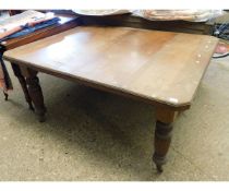 EDWARDIAN MAHOGANY EXTENDING DINING TABLE WITH CANTED CORNERS AND REEDED LEGS, RAISED ON PORCELAIN