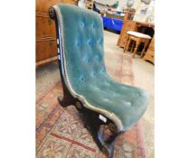 VICTORIAN EBONISED NURSING CHAIR UPHOLSTERED IN GREEN BUTTON BACK, APPLIED THROUGHOUT WITH FOLIATE