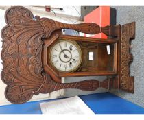 AMERICAN WALNUT CARVED MANTEL CLOCK WITH FLORAL DETAIL WITH ENAMELLED ARABIC CHAPTER RING AND GLAZED