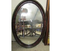 WALNUT EFFECT AND EBONISED OVAL WALL HANGING MIRROR