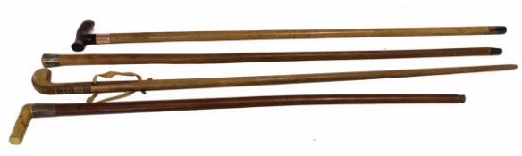 Collection of four walking canes, three with silver collars, largest 93cm high