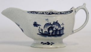Lowestoft sauce boat, circa 1765, decorated with a Chinese island pattern and a man on a sampan, the