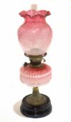 Victorian cranberry oil lamp with shaped font with etched cranberry shade and crimped edge with