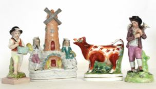 Two Staffordshire models one of a cow, one of a lighthouse, together with two pearl ware models, one