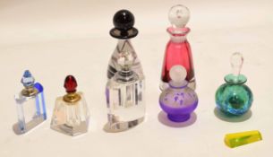 Collection of coloured faceted glass scent bottles with stoppers, largest 11cm high