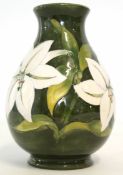 Moorcroft baluster vase decorated with white tube lined flowers on a green ground, Moorcroft stamp