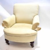 19th century mahogany framed club armchair with cream upholstery on turned and reeded squat legs,