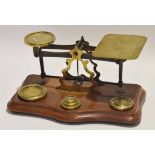 Set of late 19th/early 20th century mahogany based postal scales, together with weights, 24cm long