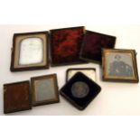 Group of vintage leather cased photographs viz Daguerrotype of family group, ambrotypes of ladies (