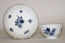 Lowestoft tea bowl and saucer of fluted form, decorated in underglaze blue with floral sprays