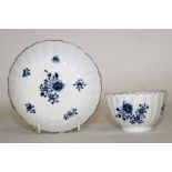 Lowestoft tea bowl and saucer of fluted form, decorated in underglaze blue with floral sprays