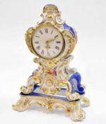Late 19th century Continental porcelain clock case and stand, the waisted case decorated