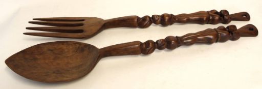 Pair of Eastern softwood over-sized spoon and fork with carved figural handles, 97cm long
