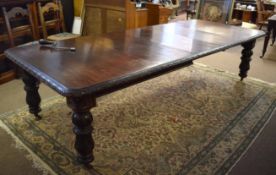 19th century Gothic oak extending dining table with carved half floral frieze supported on four