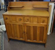 Arts & Crafts light oak Cotswold School sideboard fitted with two open shelves over two panelled