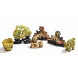 Collection of soapstone carvings of dragons and other items including a model of a skeleton and a