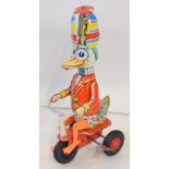 Late tinplate of a circus Duck riding a tricycle. Height approx 20cm