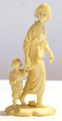 Japanese ivory figure of a lady with a young child by her side, signature to base, 14cm high