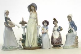 Group of Lladro models including a young girl holding geese, one with flowers, a further one