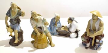 Group of Oriental pottery figures modelled as fishermen in various poses, the tallest 22cm high (4)