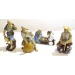 Group of Oriental pottery figures modelled as fishermen in various poses, the tallest 22cm high (4)