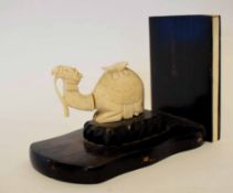 Art Deco bookend with an ivory camel seated on a wooden plinth (the camel a/f), 20cm long