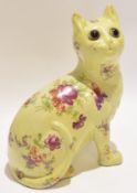 Galle style pottery cat with glass eyes, the body with floral decoration, 24cm high