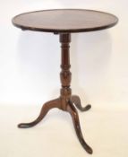 18th century oak circular tilt top table with turned urn formed column on a tripod base, top