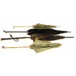 Collection of four Victorian parasols with wooden handles, tallest 90cm