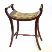 Edwardian mahogany framed concave top stool with rail sides and shaped legs supported on a turned