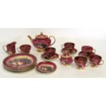 Staffordshire tea set, the red ground decorated with a printed fruit design, comprising tea pot,