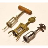 Packet: containing three steel/brass mechanical corkscrews, the brass example with crest to
