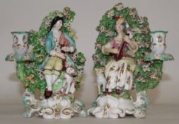 Pair of 18th century Derby candlestick figures modelled as a gentleman and a lady musician on scroll