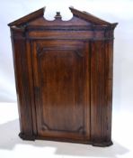Late 18th/early 19th century oak corner mounted cupboard with single panelled door with reeded