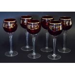 Collection of six ruby coloured wine glasses with an overlaid gilt design of fruiting vines, the