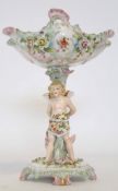 Continental porcelain centrepiece modelled with a cherub supporting the main stand, the bowl with