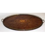 Edwardian mahogany oval inlaid tray with central motif of musical instruments and floral design with