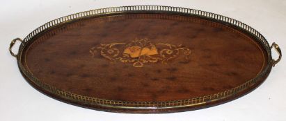 Edwardian mahogany oval inlaid tray with central motif of musical instruments and floral design with