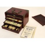 Circa early/mid 20th century wooden cased and metal mounted Mah Jong set with markers and