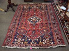 Modern thick pile multi coloured wool carpet with central red lozenge with diamond motif centre with