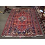 Modern thick pile multi coloured wool carpet with central red lozenge with diamond motif centre with