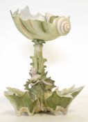 Art Nouveau centrepiece modelled as a lady sitting astride two shells, with a central column with
